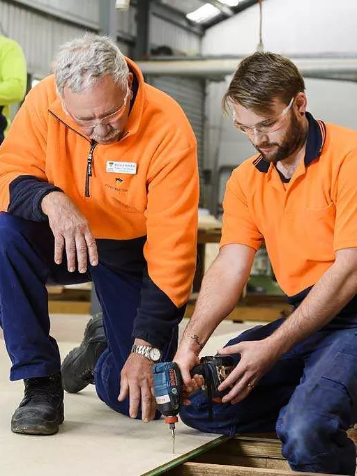 ATEC trainer giving instruction in a building course.